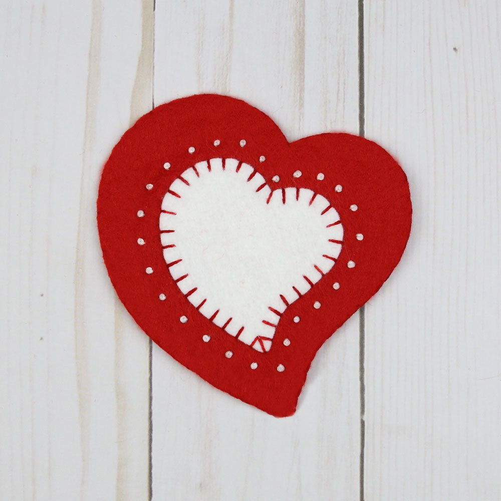 Red heart with smaller white heart and white stitching