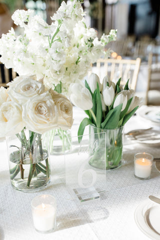 Deconstructed vase centerpiece with white flowers.