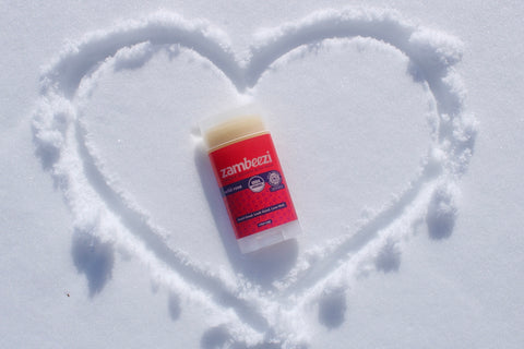 Body balm in heart drawn in snow