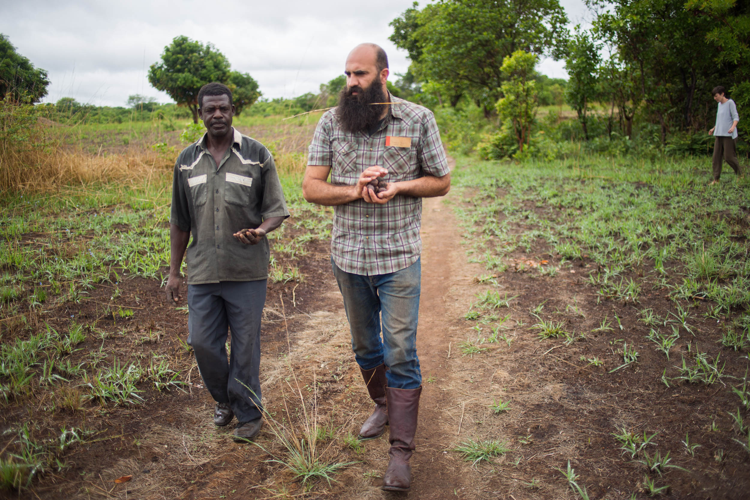 Zambeezi Founder André walking and discussing farming with Zambian Beekeeper and Arborist