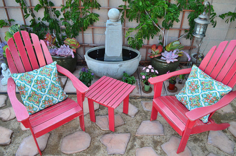 Background outdoor living with red Adirondack chairs and a fountain