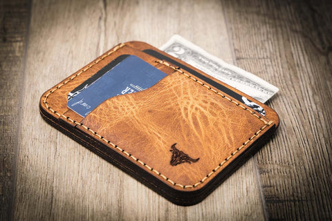A leather card holder with cleaning and conditioning instructions