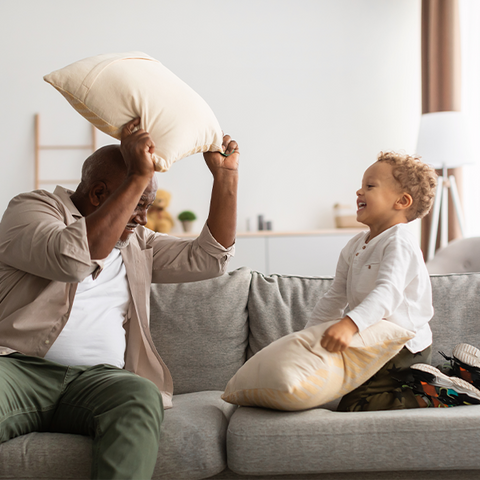 gentle pillow fight between father and son