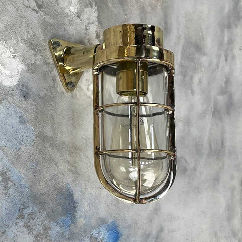 industrial brass cage wall light for a monochrome home bar