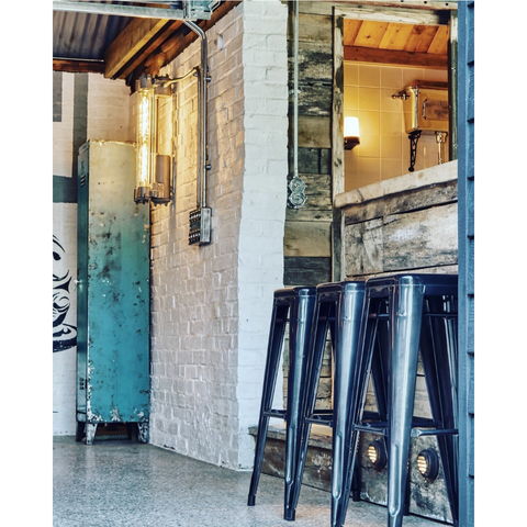 Bar in a luxury garage design project with vintage industrial lighting