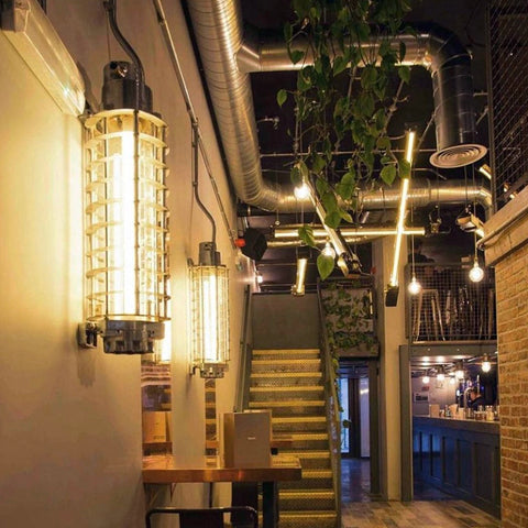 Vintage industrial wall strip lighting with LED tubes and a cage. Mounted on the wall in a industrial style bar