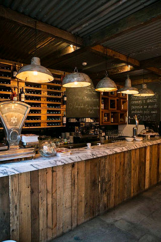 Rustic home bar with large industrial lighting
