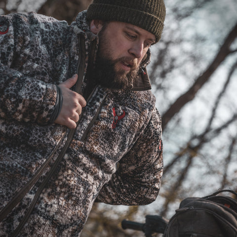 Man putting hunting pack on