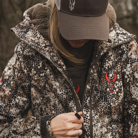 Women zipping up hunting jacket