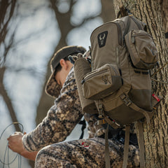 male hunter sitting on tree stand