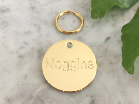Dog or puppy ID tag in luxury solid brass with personalised engraving in the UK