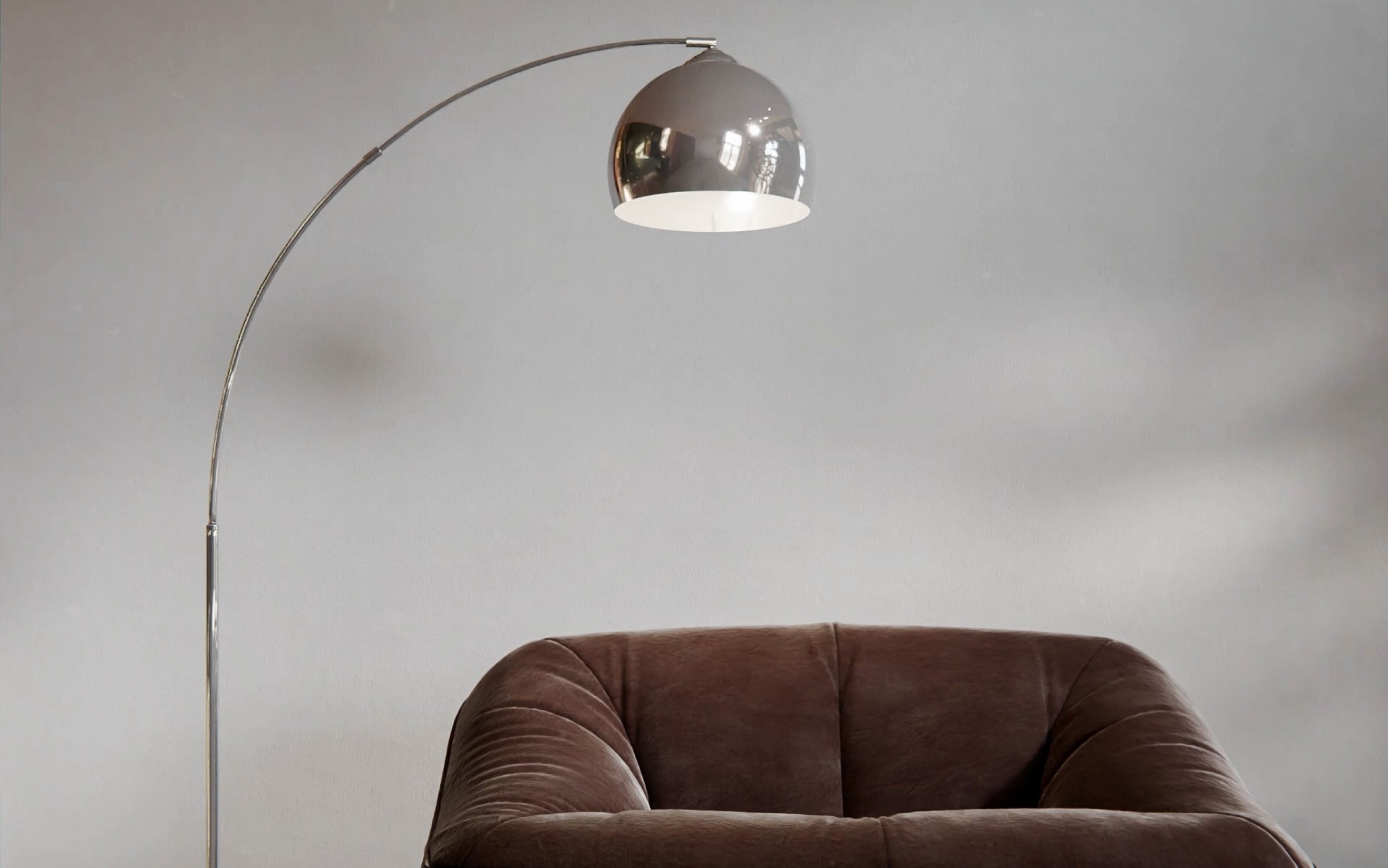 Arc Floor Lamp Hanging Over A Sofa