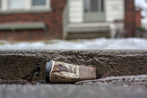 Dirty disposable cup on the street 