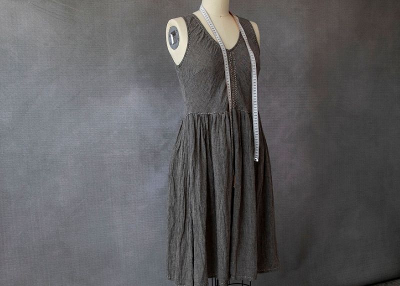 Eva Cassis dress made from sustainable fabric hanging on a mannequin