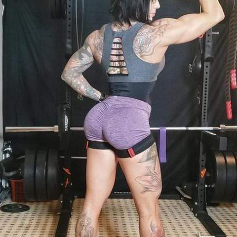 Woman flexing while wearing Leg Suppression Bands
