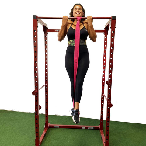 Woman performing pull-ups using anti-snap resistance bands