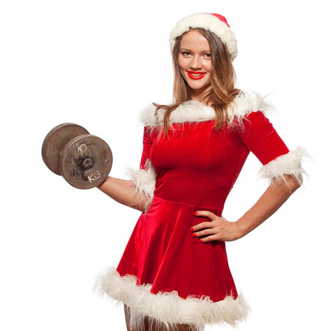 Woman in Santa Suit lifting dumbbell on white background