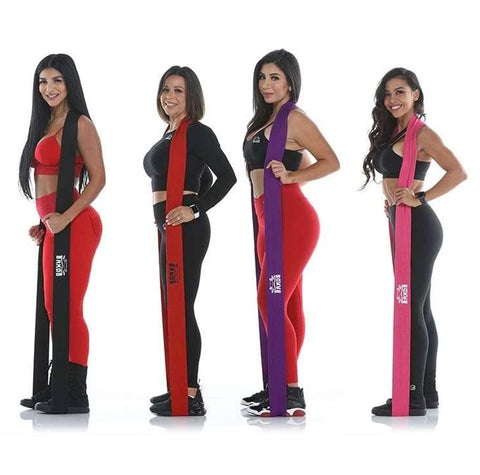4 women standing with X Bands of different sizes and colors.