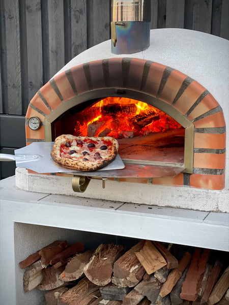 Cooking Pizza in A Wood Fire Pizza Oven