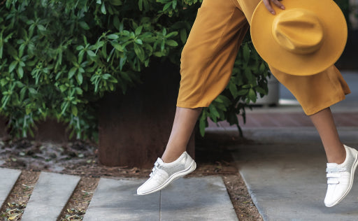 Woman in yellow pants and white SAS Shoes