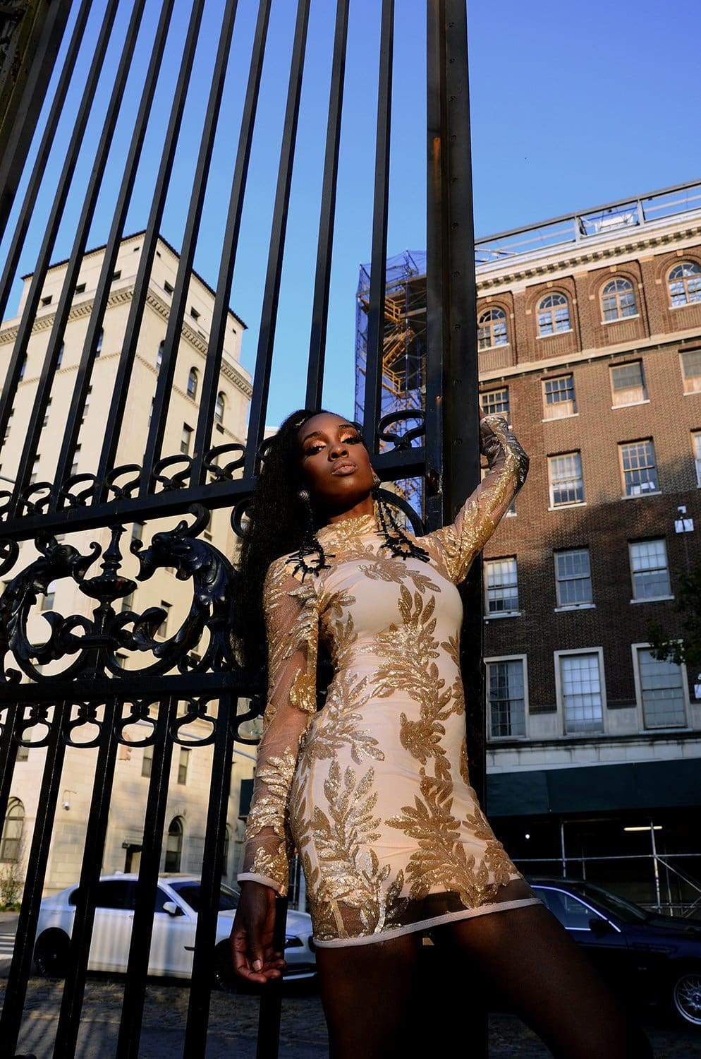 a person sitting on a bench in front of a fence