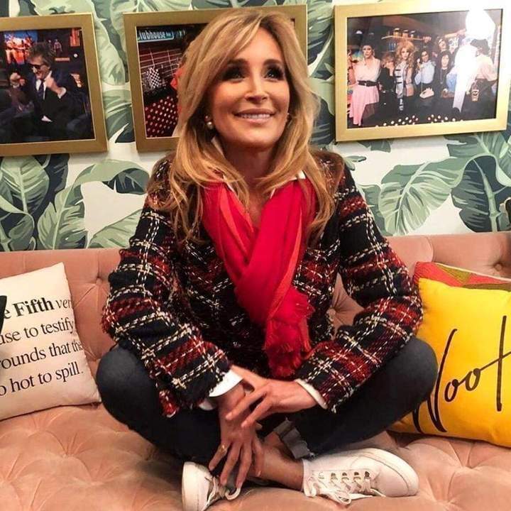 a woman sitting at a table posing for the camera