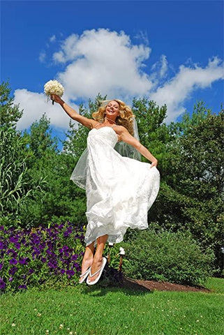 bride wearing flip flops and jumping in the air