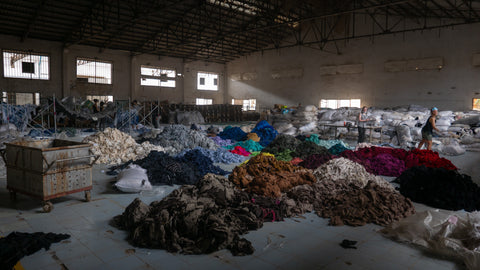 warehouse with tons of clothing in an abandoned factory