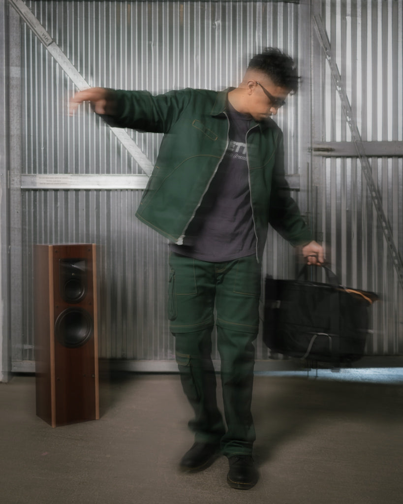 Elfernandosez modeling for unsettle frequency collection with workwear jacket and cargo pants full shot