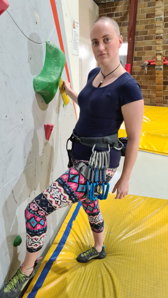 Tori wearing the Garnet at vertical reality about to climb