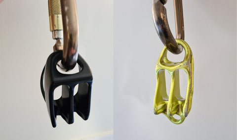 Singing Rock Shuttle hanging from a carabiner, the attachment point loop is smaller then the Petzl Reverso