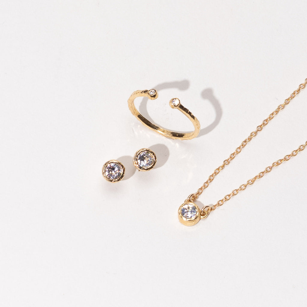 Dainty, delicate gold April Birthstone necklace, earrings and ring from the Birthstone Collection. Minimalist jewelry made in America by Katie Dean Jewelry.