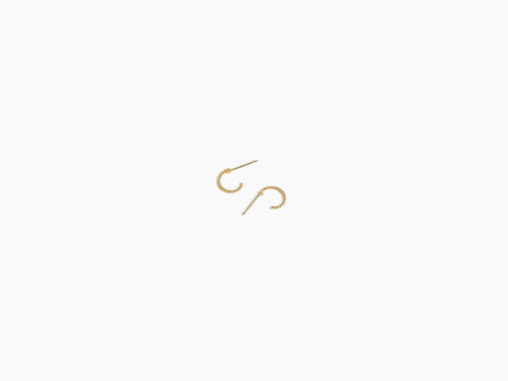 Dainty gold, nickel-free Beaded Hoop Studs by Katie Dean Jewelry on a white background, showcasing the intricate beadwork and 18k gold finish.