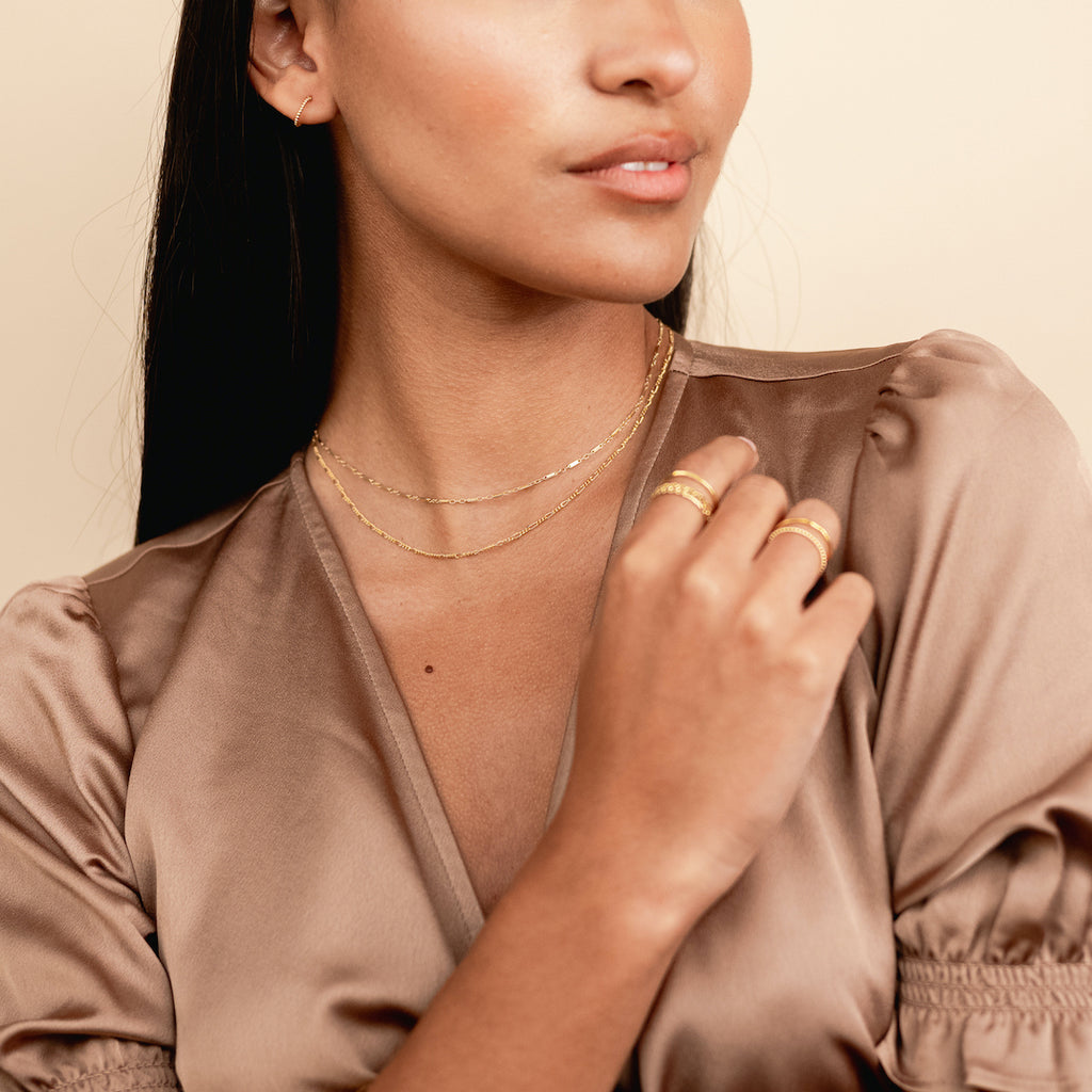 A How-To guide on elevating your everyday style with minimalist jewelry featuring the dainty gold Linked Necklace hand assembled in America by Katie Dean Jewelry.