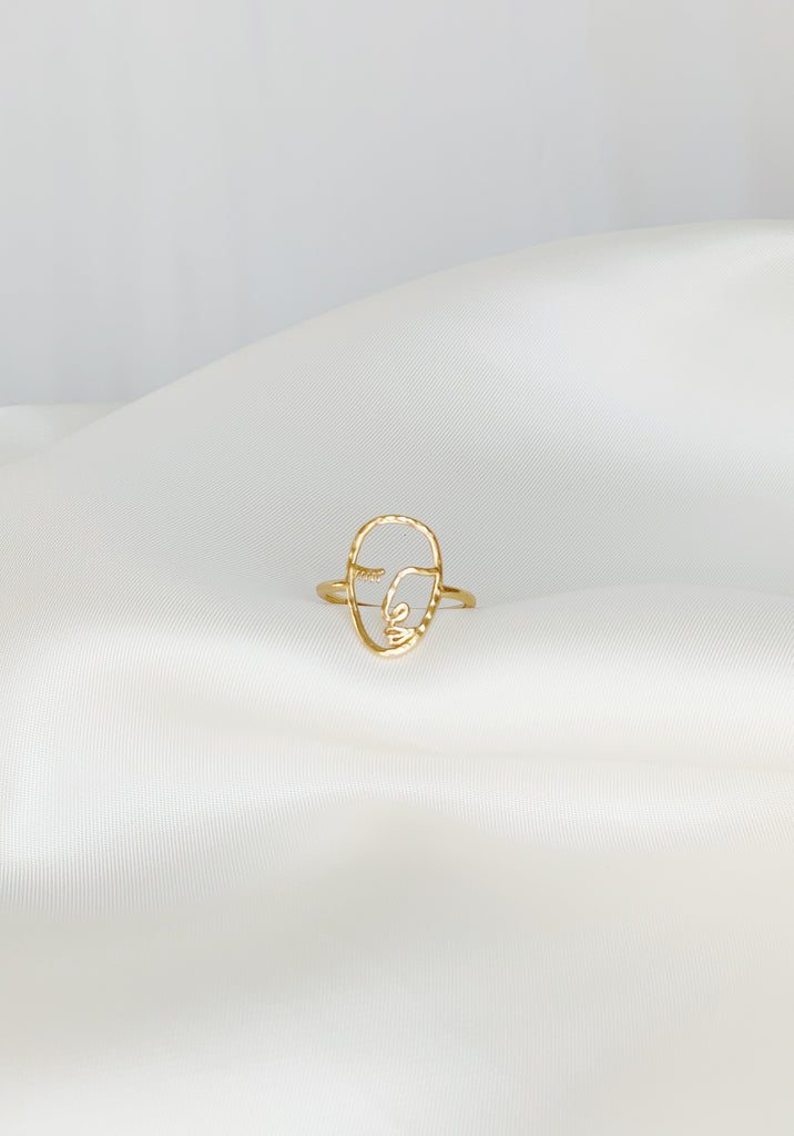 Katie Dean Jewelry Artist Face Ring with classic line art design presented on a smooth satin background.