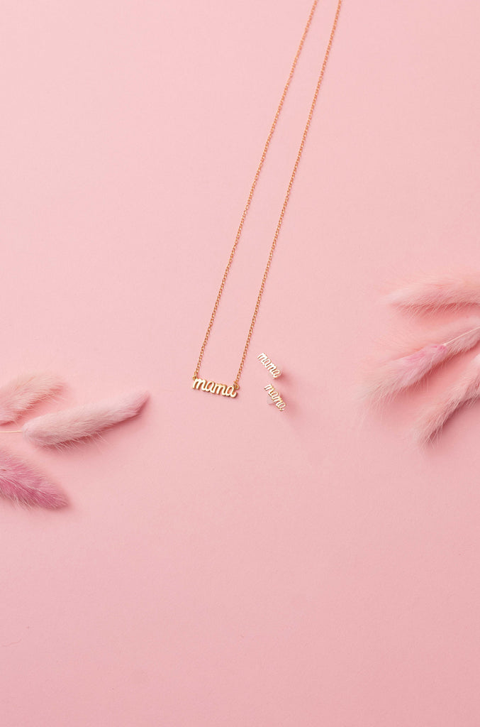 Elegant Mother’s Jewelry, created to celebrate motherhood and made in America by Katie Dean Jewelry, discover the dainty gold Mama Necklace and Mama Stud Earrings.