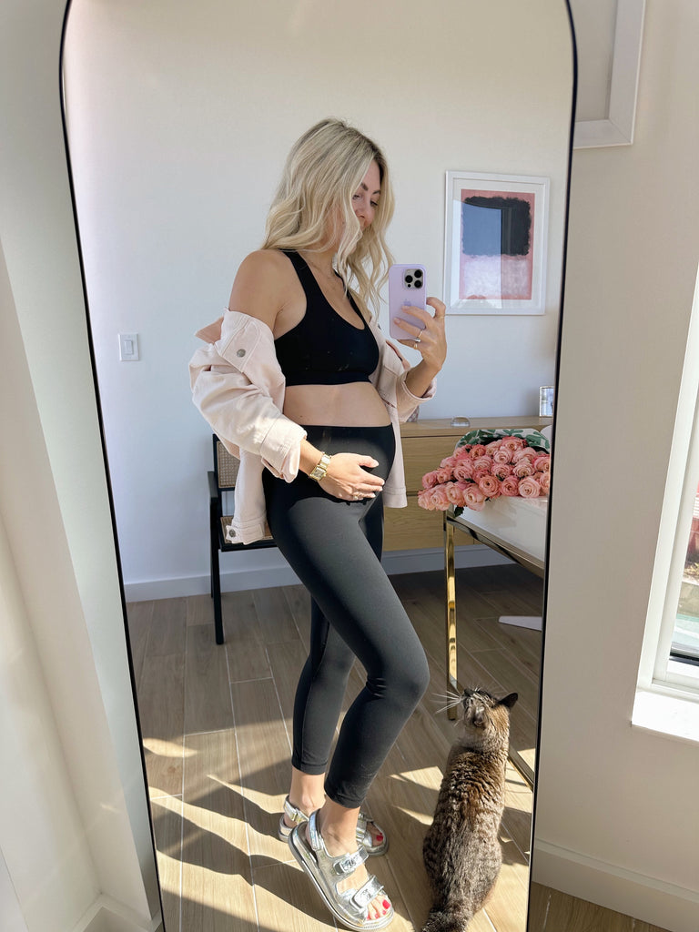 Founder of Katie Dean Jewelry, Katie showing off her baby bump at 5 months pregnant with baby girl wearing the Mama Necklace and Mama Ring from her jewelry line.