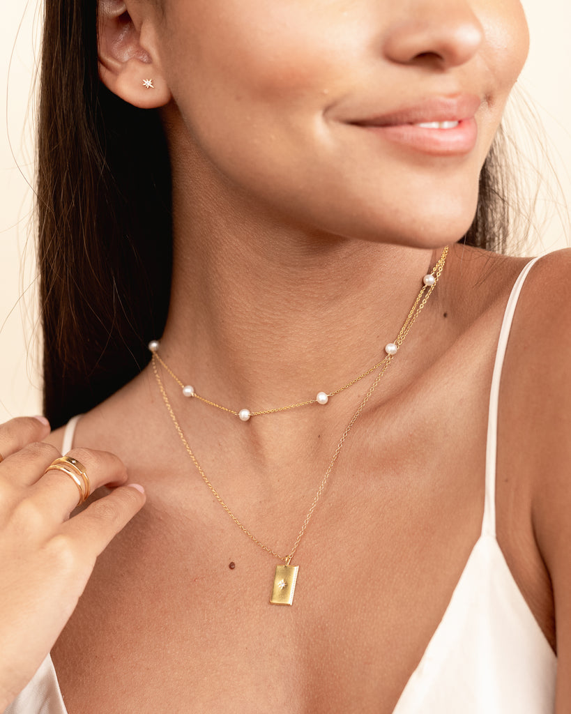 Dainty, delicate Pearl Necklace as seen on a model, designed by Katie Dean Jewelry and made in America.