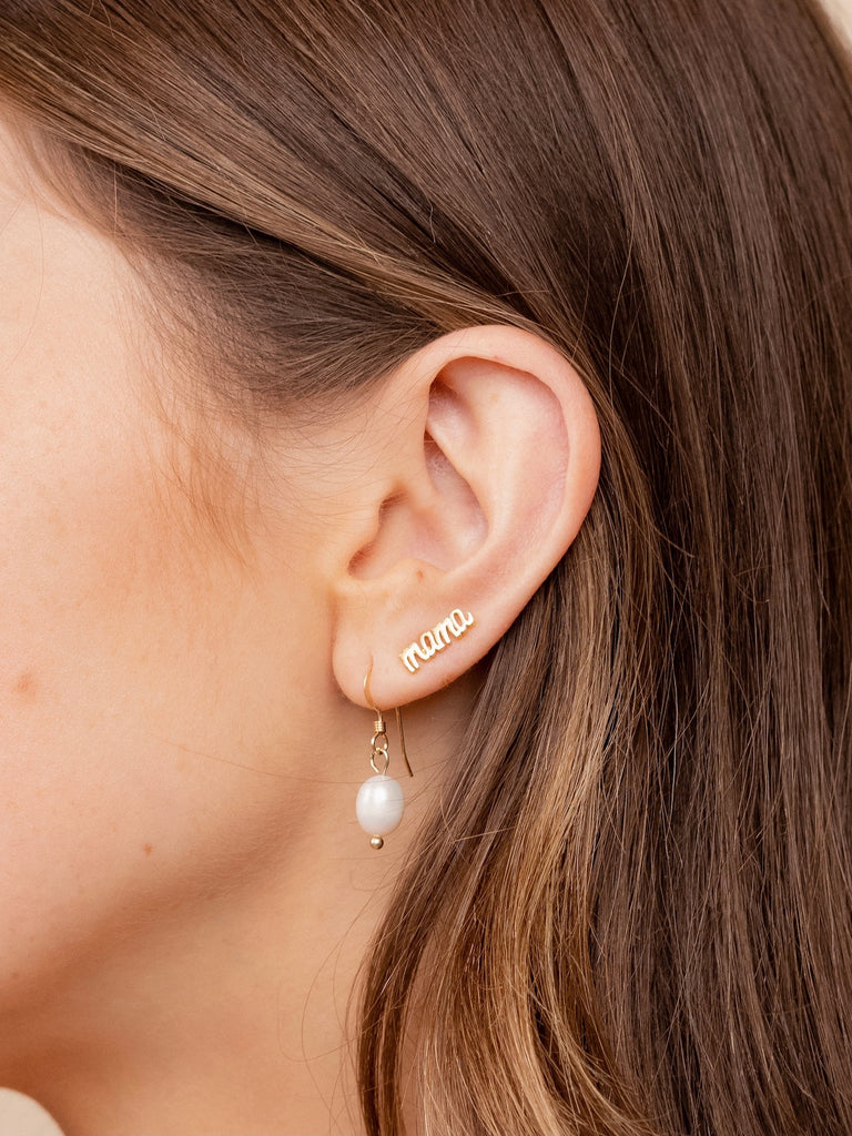 Dainty, delicate Pearl Drop Earrings as seen on a model, designed by Katie Dean Jewelry and made in America.