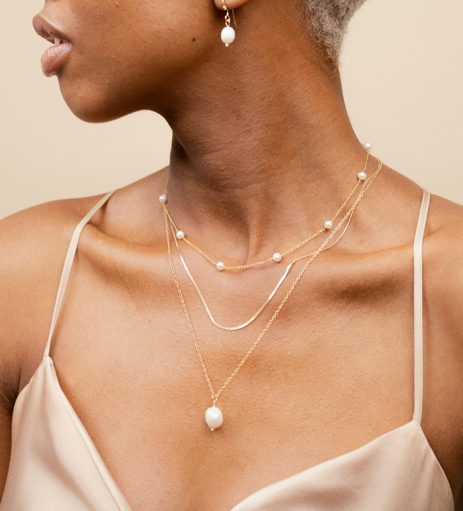 Dainty, delicate Pearl Collection as seen on a model, designed by Katie Dean Jewelry and made in America