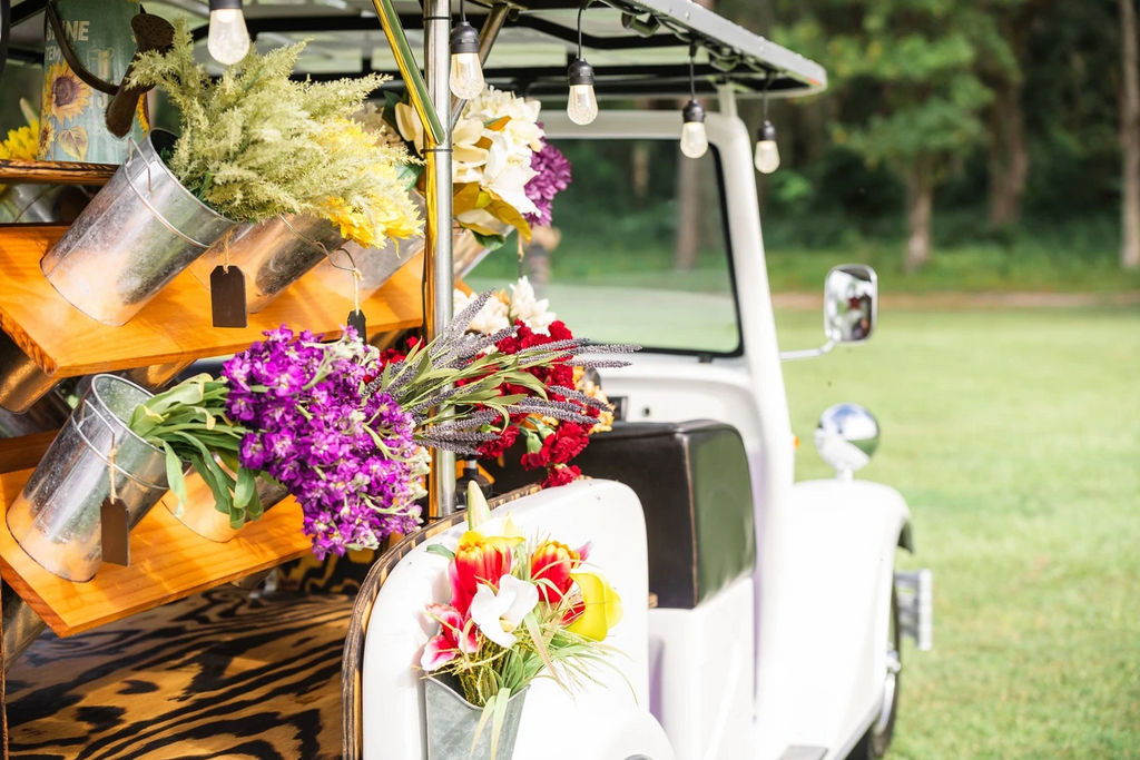 Image of the white Poise flower truck with flowers in buckets.