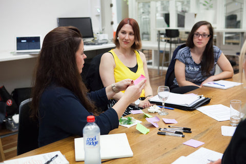 Women sitting at table working together