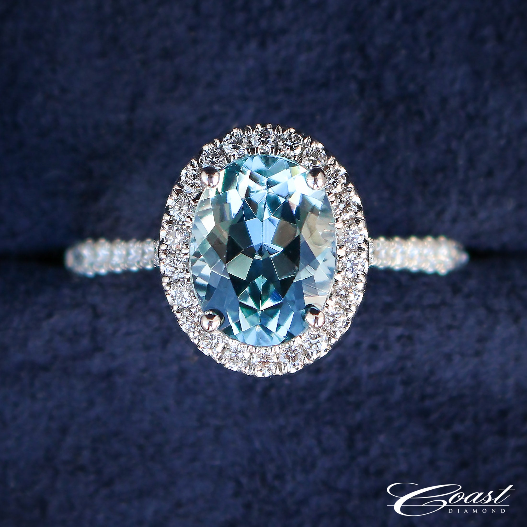 Oval cut aquamarine and diamond halo ring by Coast Diamond