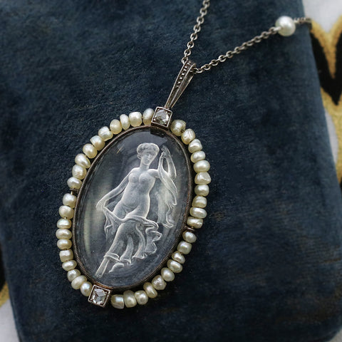 carved quartz pendant with a seed pearl frame