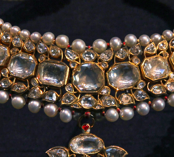 close up of mirror cut diamonds in necklace