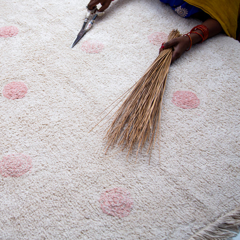 trimming a hand tufted cotton rug Lorena Canals at Rugs by Roo