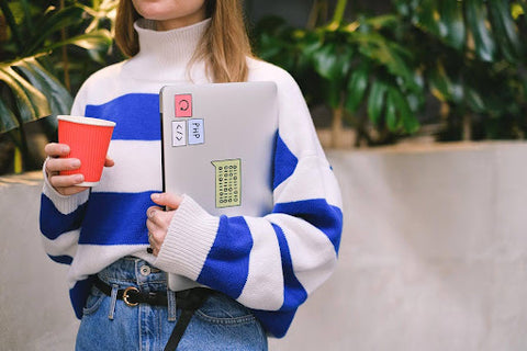 woman with laptop and disposable cup