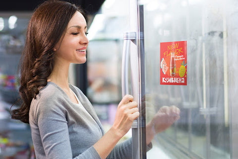 Woman opening reach-in refridgerator