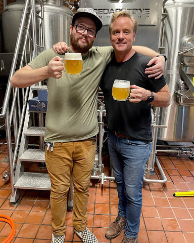 Father and son Dylan Emmons and Tom Emmons holding a pint