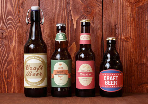 plain craft beer bottles lined up against wood background